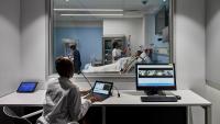 View of labor and delivery simulation room from behind one way glass where professor can give instructions.